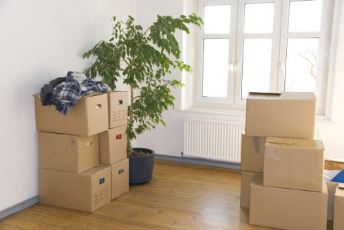 Boxes and furniture arranged for a small flat move in Kingsbury